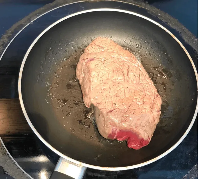 Searing beef in a hot pan to get a perfect crust